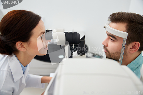 Image of optician with tonometer and patient at eye clinic