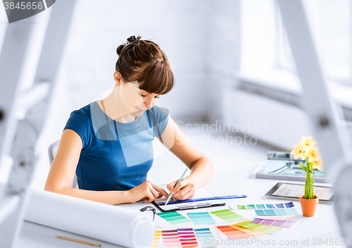 Image of woman working with color samples for selection