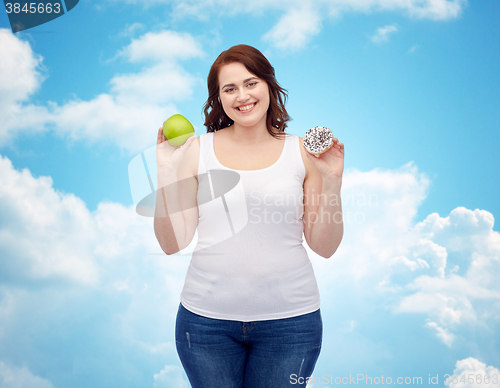 Image of happy plus size woman choosing apple or cookie