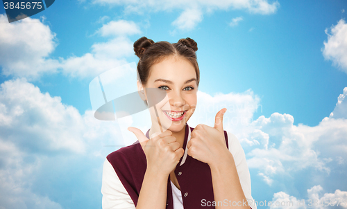 Image of happy smiling teenage girl showing thumbs up