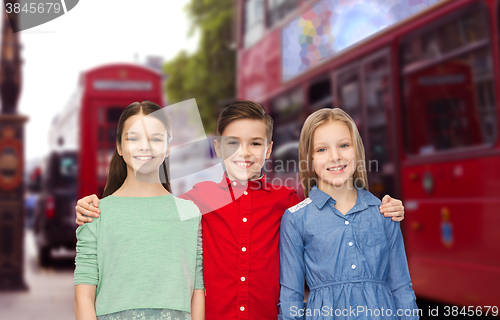 Image of happy boy and girls hugging over london city