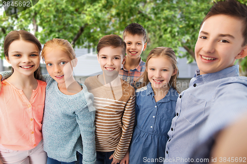 Image of happy children talking selfie over backyard