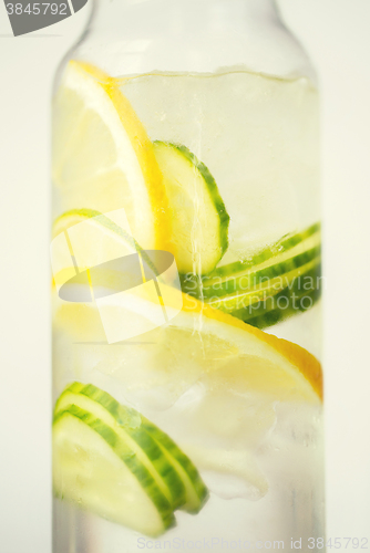 Image of close up of fruit water in glass bottle