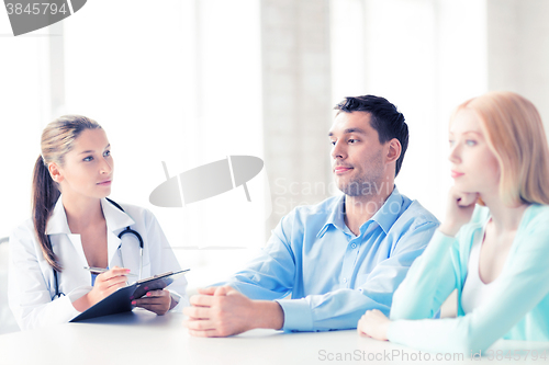 Image of doctor with patients in cabinet