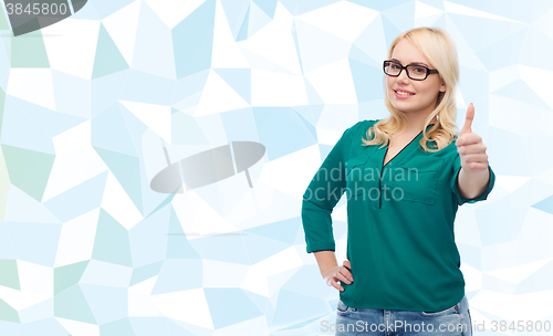 Image of young woman in eyeglasses showing thumbs up