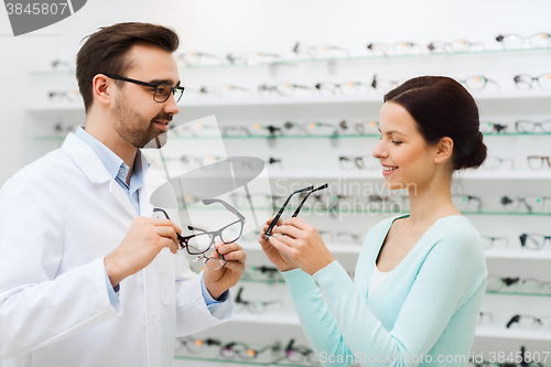 Image of woman and optician showing glasses at optics store