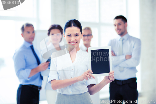 Image of businesswoman with tablet pc in office