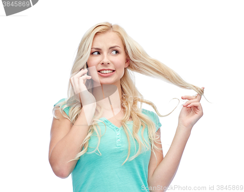 Image of smiling young woman calling on smartphone