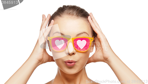 Image of surprised teenage girl in pink sunglasses