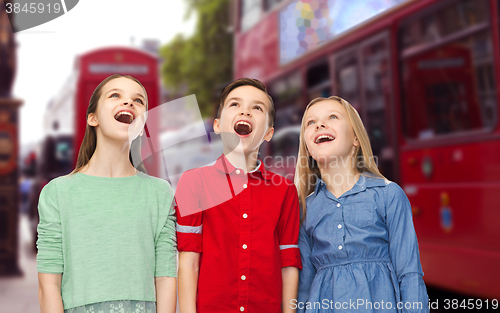 Image of amazed boy and girls looking up over london city