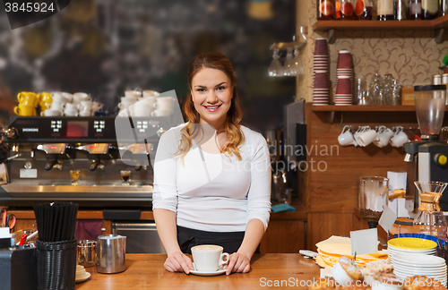 Image of happy barista woman with latte at coffee shop
