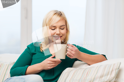 Image of happy young woman at home