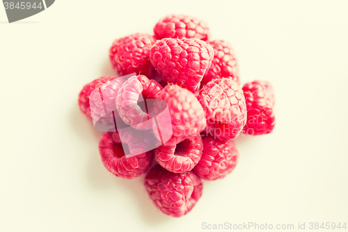 Image of juicy fresh ripe red raspberries on white