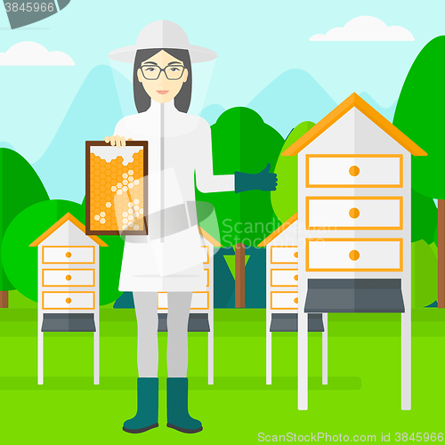 Image of Bee-keeper at apiary.