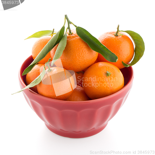 Image of Tangerines on ceramic red bowl 