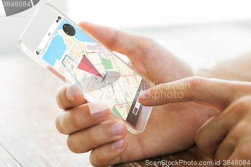 Image of close up of hand with navigator map on smartphone