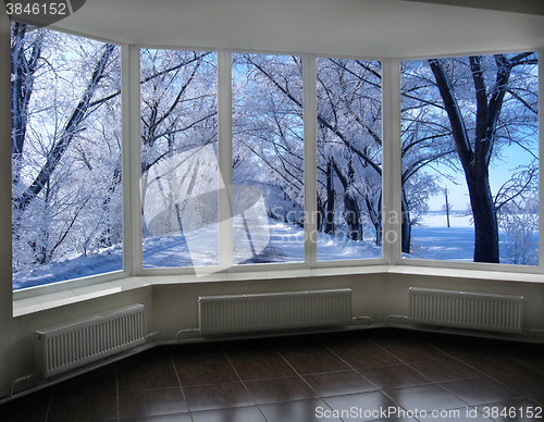 Image of windows overlooking the winter road with trees in hoarfrost