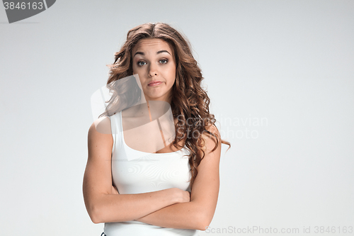 Image of The happy thoughtful woman on gray background