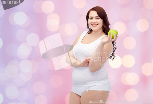 Image of happy plus size woman in underwear with apple