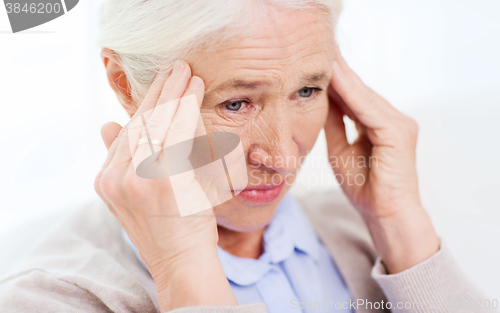 Image of face of senior woman suffering from headache