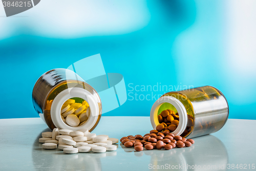 Image of Pills on a table with two glasses