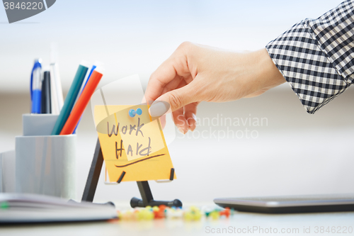 Image of Work hard text on adhesive note