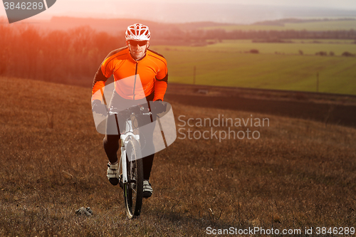 Image of Man cyclist with backpack riding the bicycle