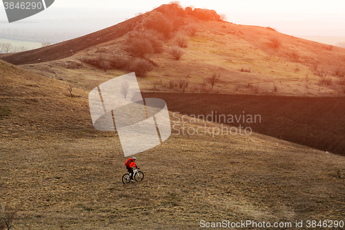 Image of Man cyclist with backpack riding the bicycle