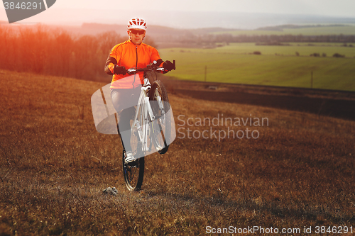 Image of Man cyclist with backpack riding the bicycle