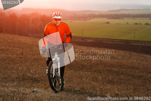 Image of Man cyclist with backpack riding the bicycle