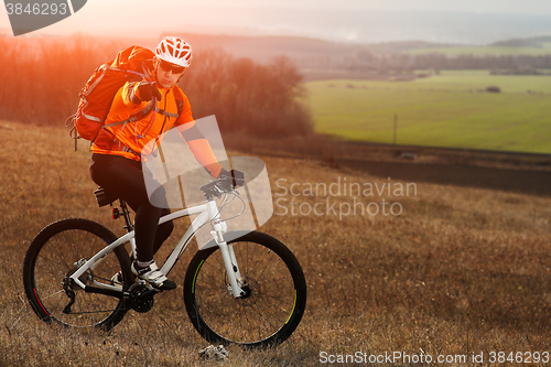 Image of Man cyclist with backpack riding the bicycle