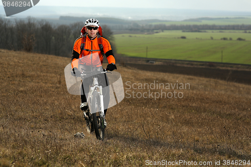 Image of Man cyclist with backpack riding the bicycle