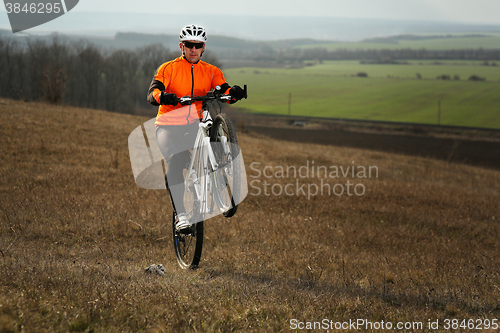 Image of Man cyclist with backpack riding the bicycle