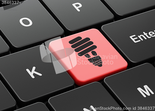Image of Finance concept: Energy Saving Lamp on computer keyboard background