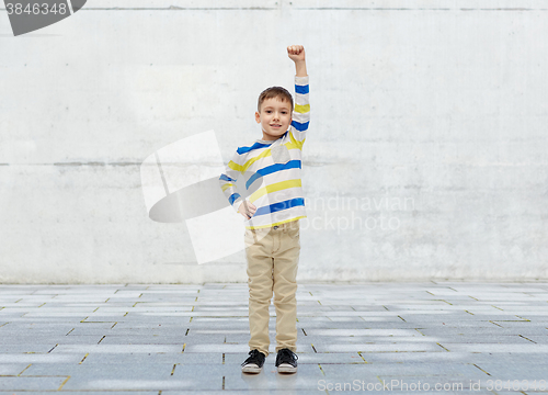 Image of happy smiling little boy with raised hand