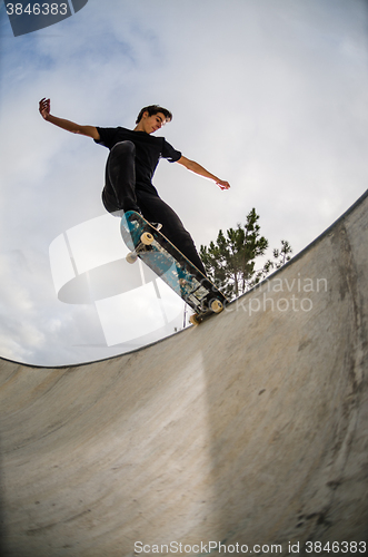 Image of Skateboarder doing a tail slide