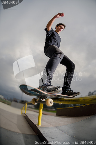 Image of Skateboarder doing a board slide