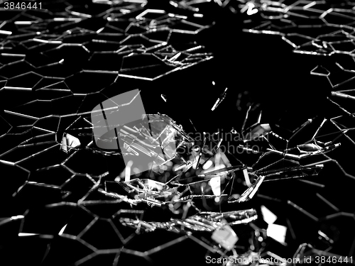 Image of Destructed and splitted glass pieces on black