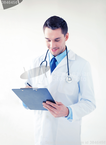 Image of male doctor writing prescription