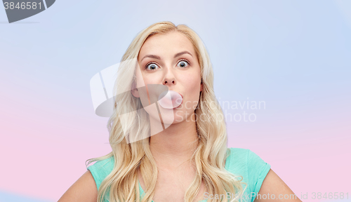 Image of happy young woman or teenage girl chewing gum