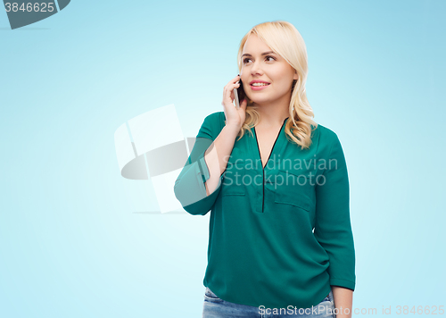 Image of happy young woman calling on smartphone