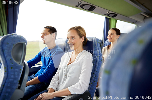 Image of group of happy passengers in travel bus