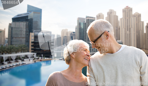 Image of senior couple hugging over dubai city waterfront