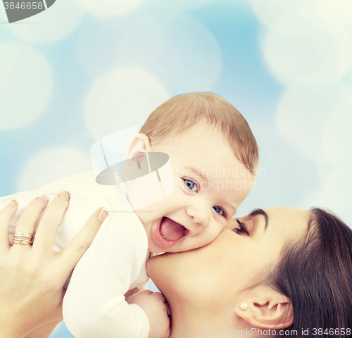 Image of laughing baby playing with mother