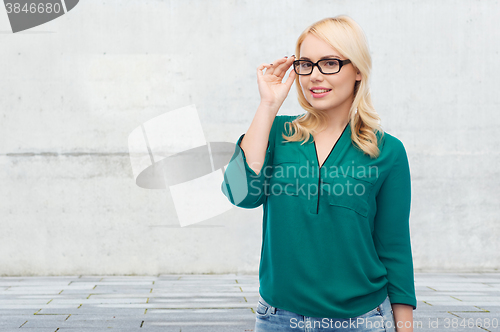 Image of smiling young woman with eyeglasses