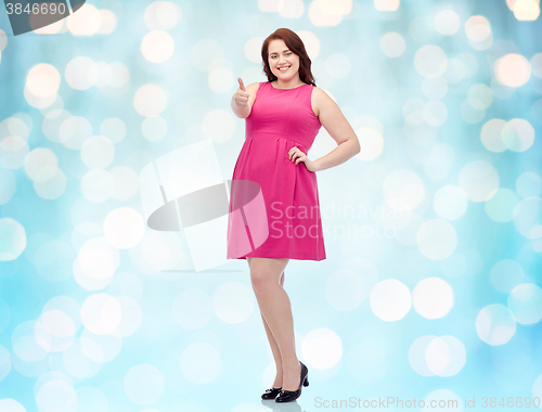 Image of happy young plus size woman showing thumbs up