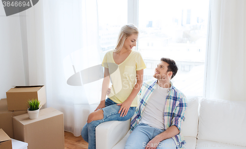 Image of happy couple with big cardboard boxes at new home