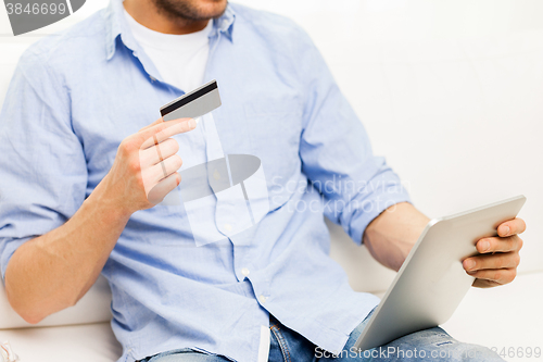 Image of close up of man with tablet pc and credit card