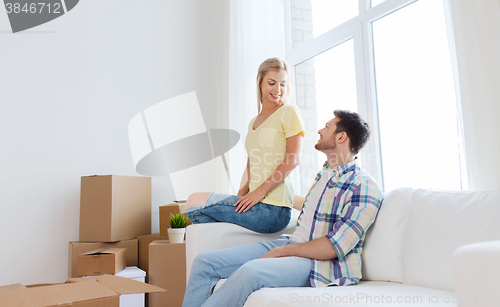 Image of happy couple with big cardboard boxes at new home