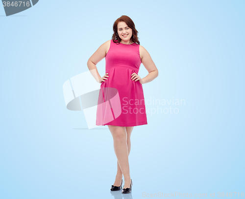 Image of happy young plus size woman posing in pink dress